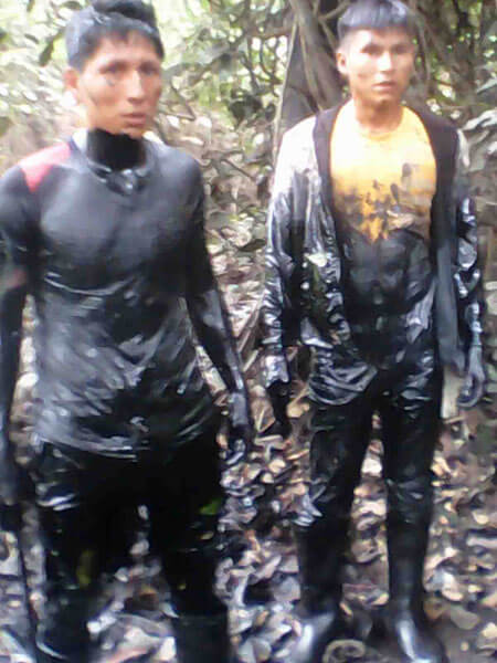 Local men were covered with oil after being hired to find the leak in the submerged pipeline. (Photo: Municipality of Urarinas)