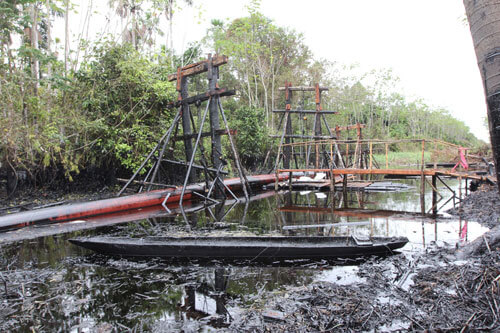 Scaffolding holds a broken section of the oil pipeline. (Photo: Barbara Fraser)