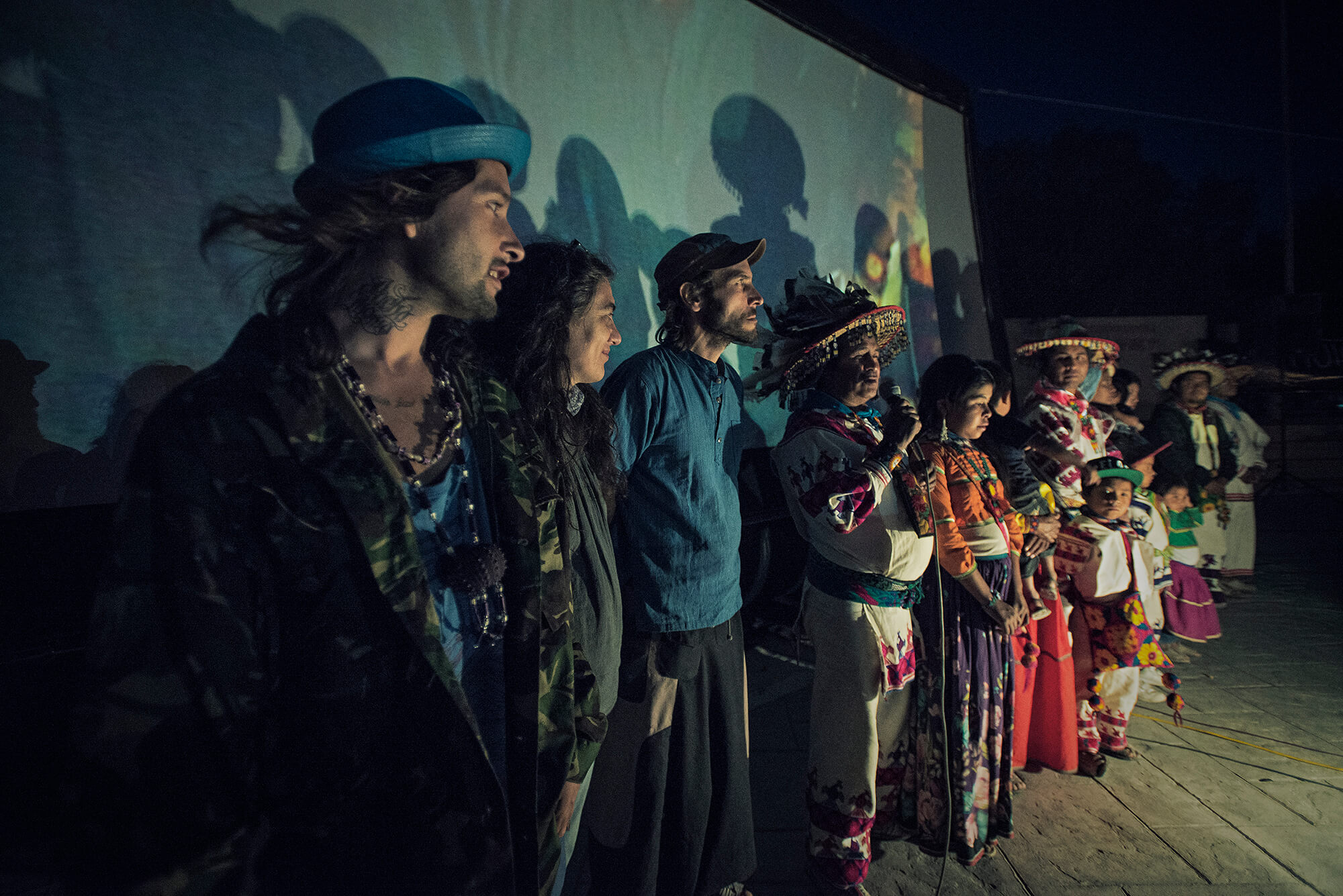 José Luis "Katira" Ramírez introduces the film in Estación Catorce, in the sacred territory of Wirikuta, flanked by the film crew and his family. (Credit: José Andrés Solórzano) 