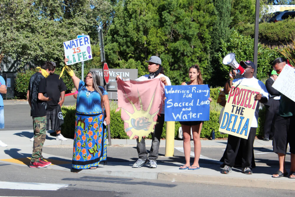 Protesters gather in front of the Westin Hotel to protest Governor Brown's Water Summit for the Rich. Photo by Dan Bacher.