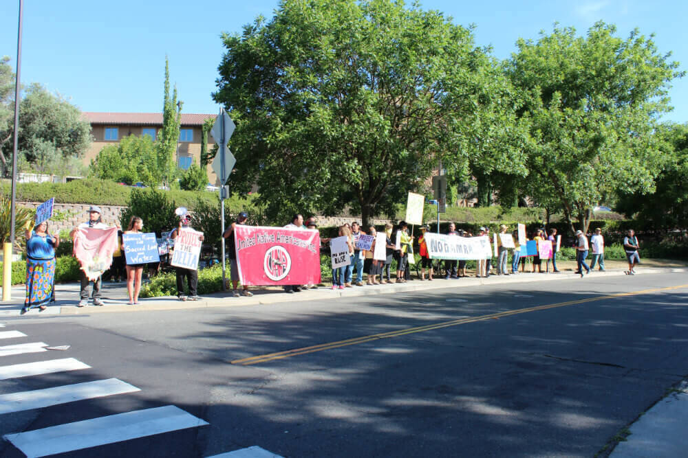 Protesters line the street in front of the Westin Hotel in Sacramento to blast Governor Brown's exclusion of Tribes and their allies from the summit. Photo by Dan Bacher.