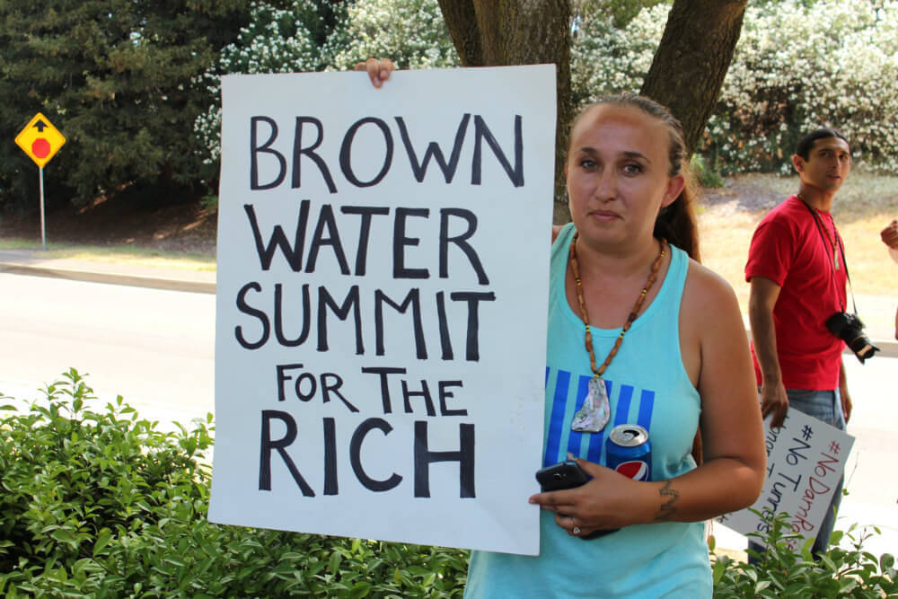 Jessica Lopez, Vice Chair of the Concow Maidu Tribe, lets Governor Brown know how she feels about the California Water Summit. Photo by Dan Bacher.