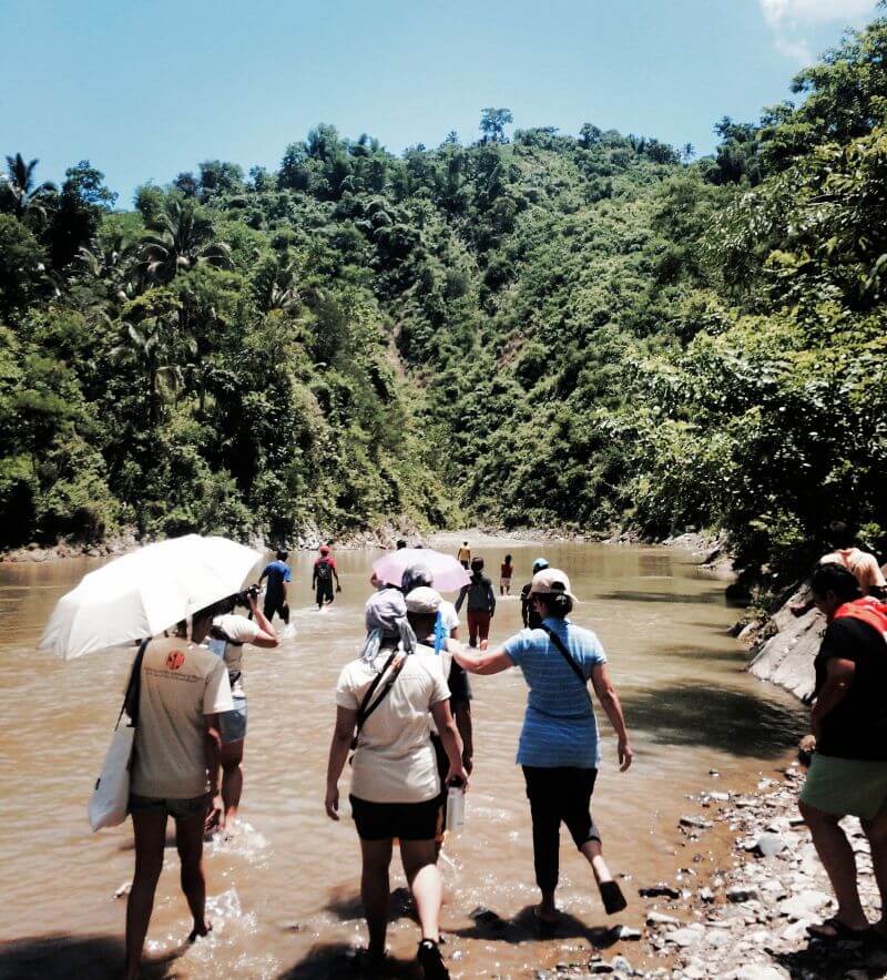 Delegates of the International Solidarity Mission fording the Jalaur River.