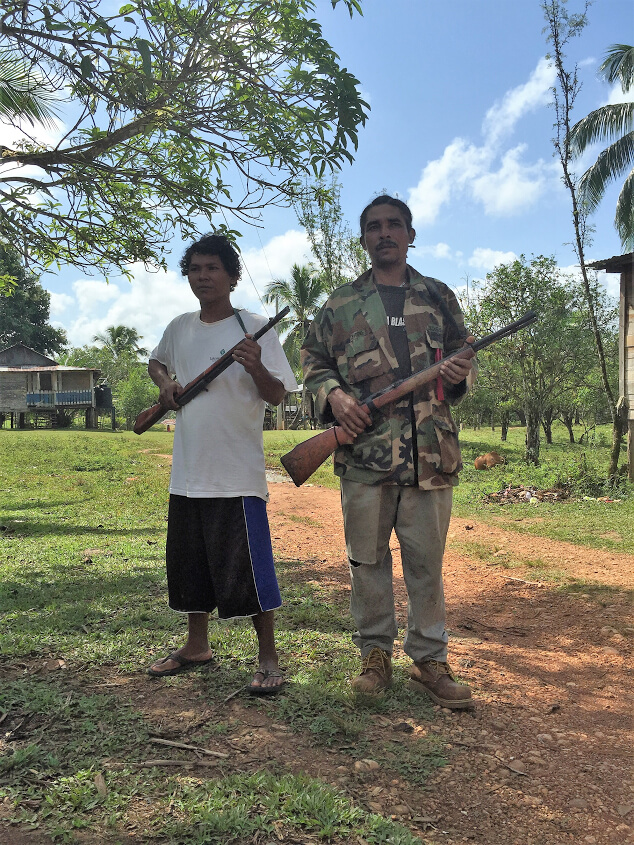 Two Miskitu community defenders pose for a picture in the frontier community of Wisconsin. Photo by Courtney Parker.
