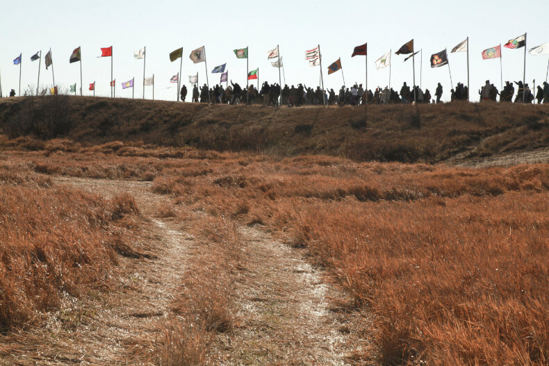 Prayer walk led by the international Indigenous youth council towards the police blockade outside the Oceti Sakowin camp, Nov. 4. Photo: Max Collins