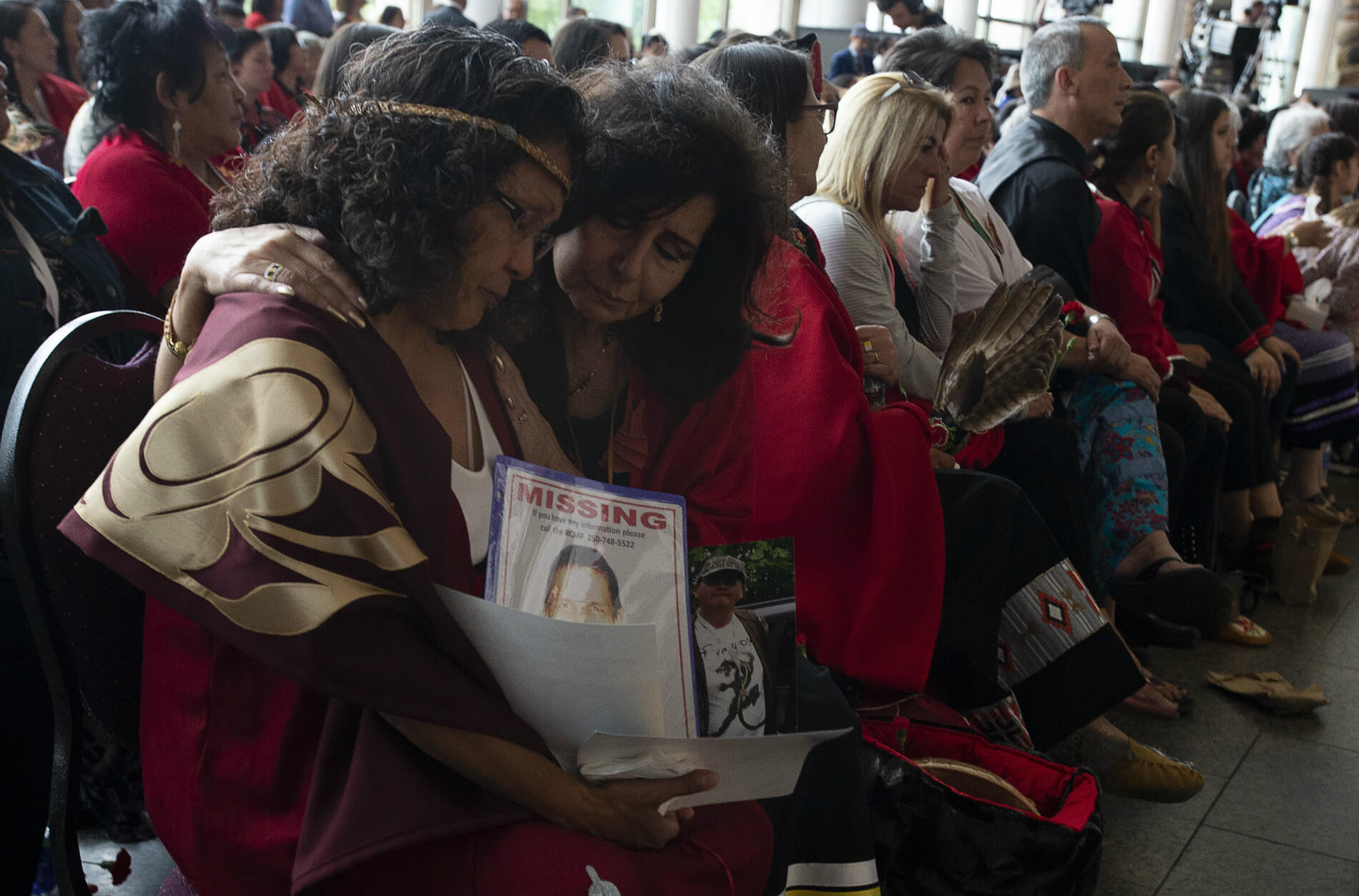 Two women embrace during ceremonies marking the release of the Missing and Murdered Indigenous Women and Girls report