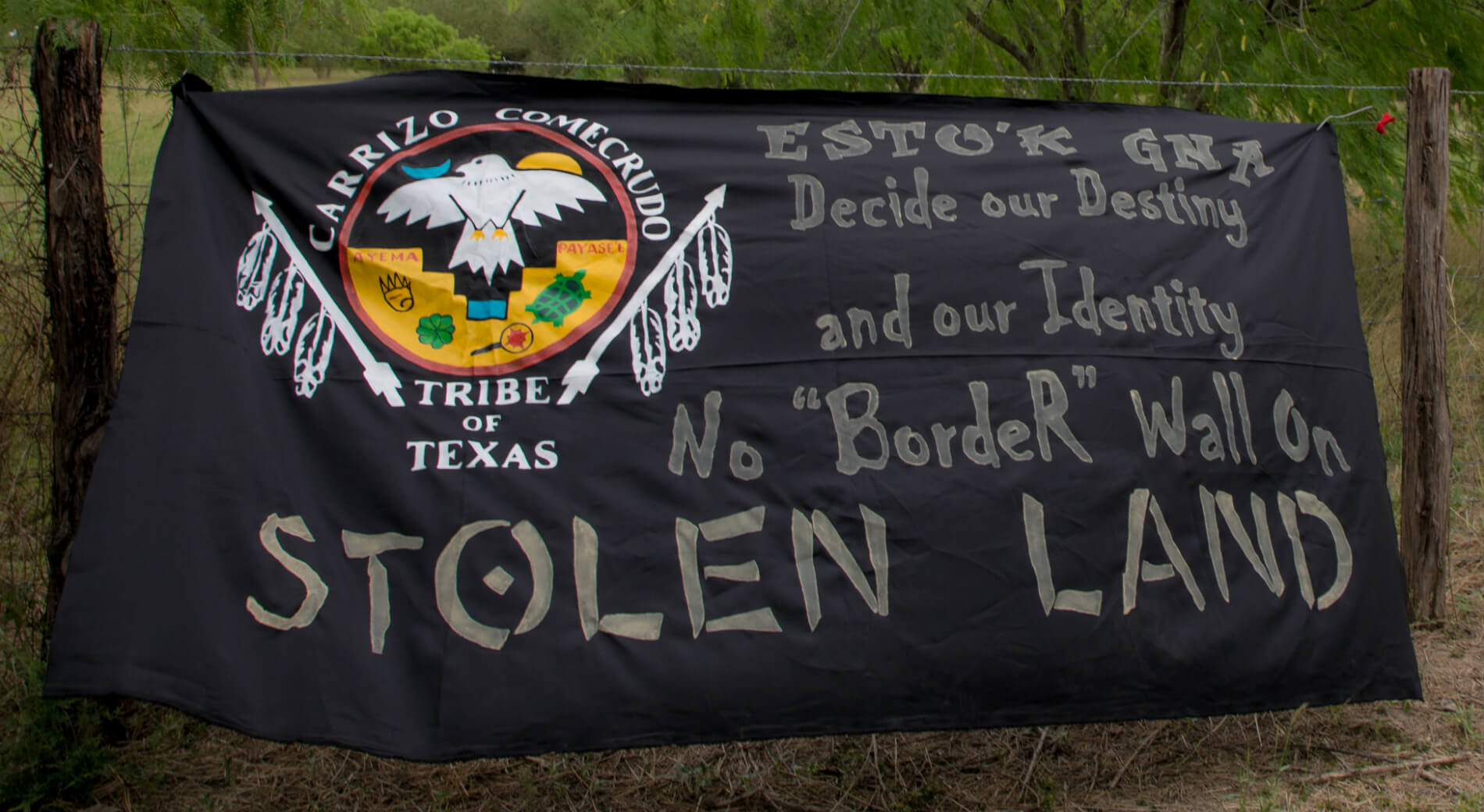 Esto'k Gna banner hanging at Mariposa Village. 
