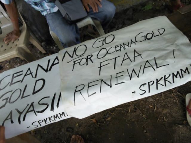 Placards from community blockade of OceanaGold’s Didipio Mine site.