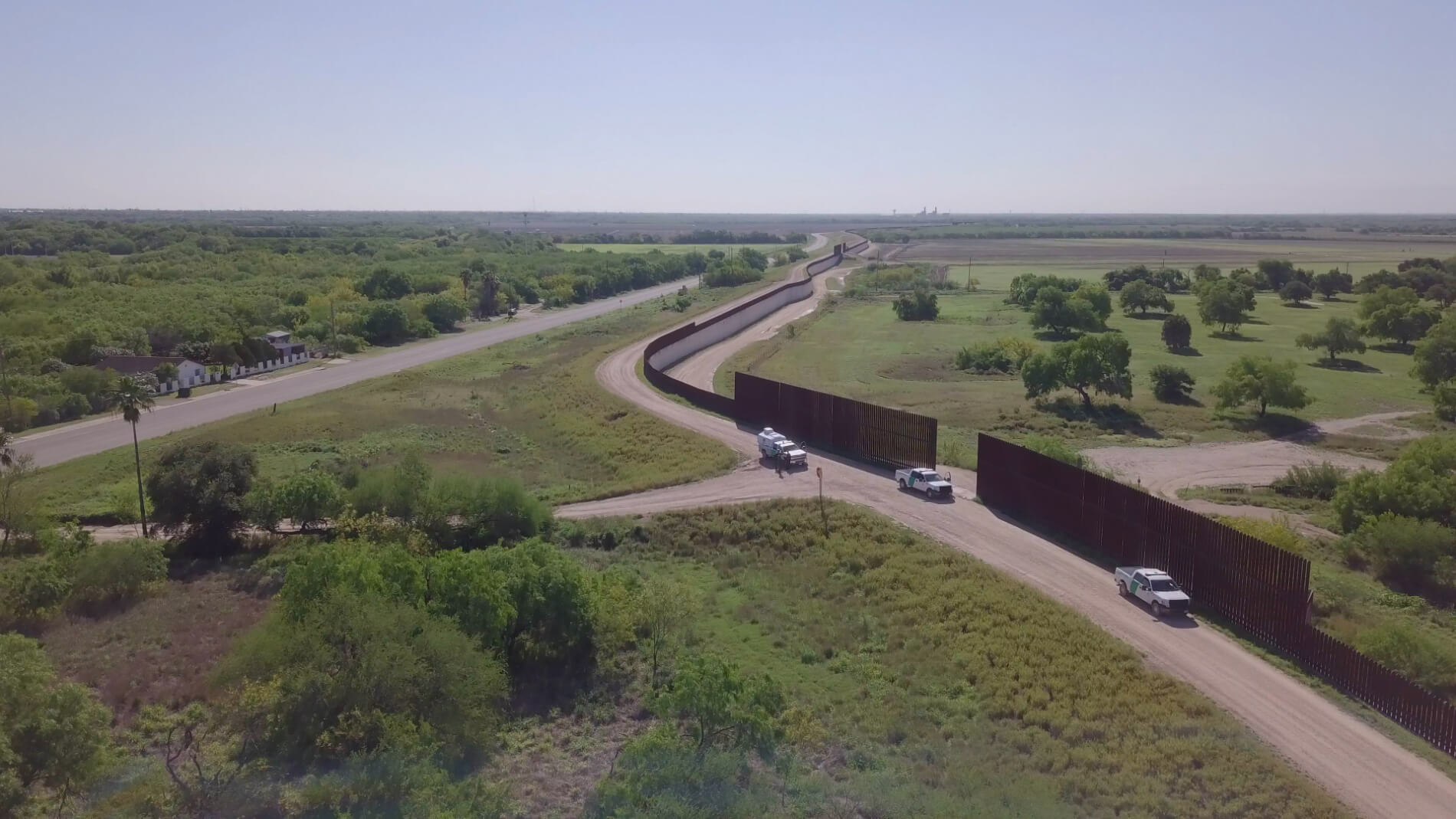 Border Patrol patrolling near border wall construction